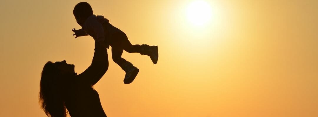 Pathways1 This is an image of a silhouetted mother swinging a young child above her head against a sunset